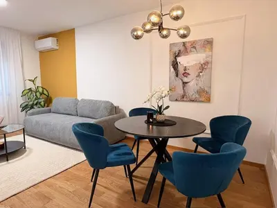 a living room with a couch and a table and chairs at Room 66