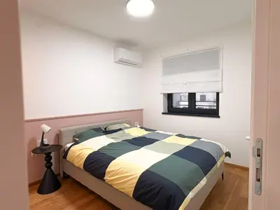 a bedroom with a bed and a window at Room 66