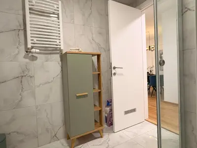 a bathroom with a shower and a glass door at Room 66