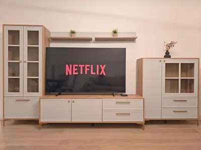 a television on top of a white entertainment center at Eterna Premium Apartment 1 Bedroom in Sajmište