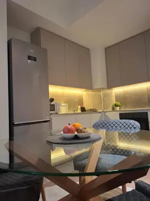 a kitchen with a glass table with a bowl of fruit on it at Belgrade Waterfront-BW Hena in Belgrade