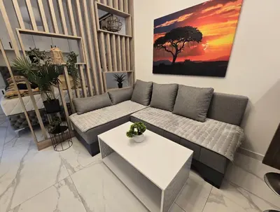 a living room with a couch and a table at White Queen in Bukorovac