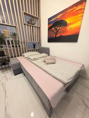 a bedroom with a bed with a painting on the wall at White Queen in Bukorovac