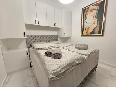 a bed in a room with white cabinets at White Queen in Bukorovac