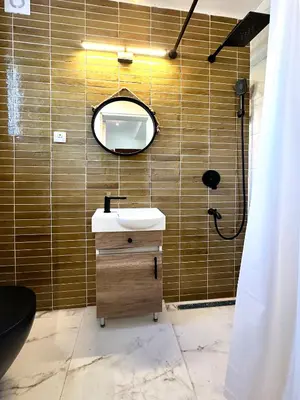 a bathroom with a sink and a mirror at Mali Raj in Mala Ivanča