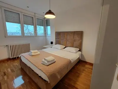 a bedroom with a large bed with two towels on it at Fontana in Belgrade