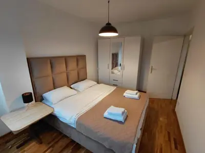 a bedroom with a bed with two towels on it at Fontana in Belgrade