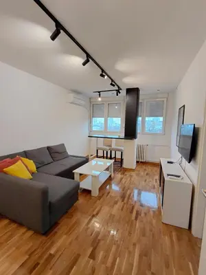 a living room with a couch and a flat screen tv at Fontana in Belgrade