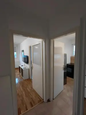 an empty room with two doors and a kitchen at Fontana in Belgrade
