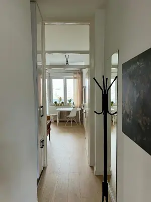 a hallway with a living room with a dining table at City Heart Studio, City Center in Belgrade