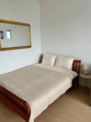 a bedroom with a bed with a mirror on the wall at City Heart Studio, City Center in Belgrade