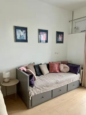 a couch with pillows on it in a room at City Heart Studio, City Center in Belgrade