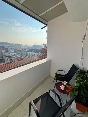 a balcony with a table and chairs and a view at City Heart Studio, City Center in Belgrade