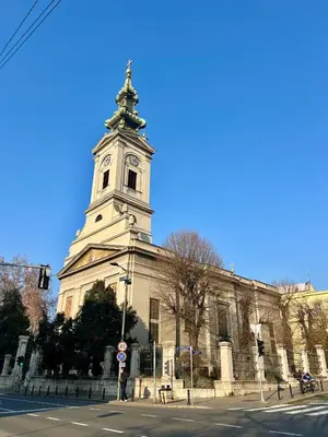 a large building with a tower with a clock on it at City Heart Studio, City Center in Belgrade