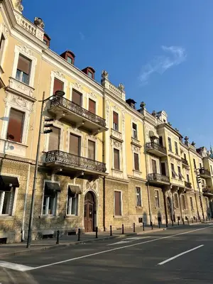 a large yellow building on the side of a street at City Heart Studio, City Center in Belgrade
