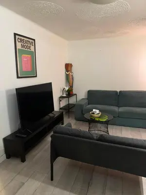 a living room with a couch and a tv at BelgradeCenterVibe in Belgrade