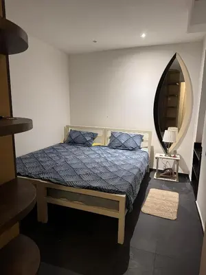 a bedroom with a bed with a blue comforter at BelgradeCityVibe in Belgrade