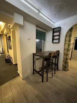 a dining room with a wooden table and chairs at BelgradeCityVibe in Belgrade