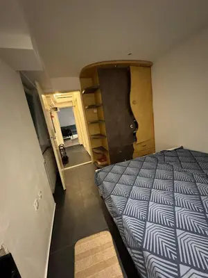 a small bedroom with a bed and a door at BelgradeCityVibe in Belgrade