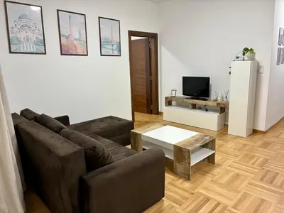 a living room with a couch and a table at VHome in Belgrade