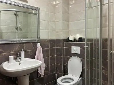 a bathroom with a toilet and a sink at VHome in Belgrade