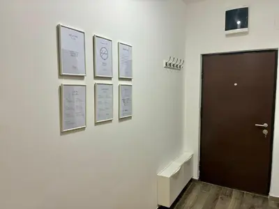 a hallway with a door and pictures on a wall at VHome in Belgrade