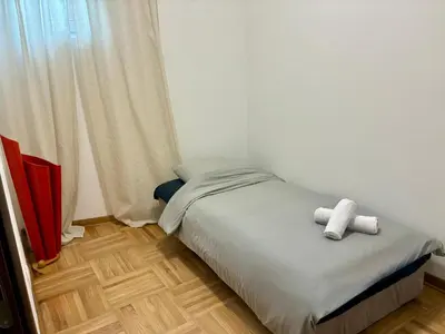 a bedroom with a bed with two towels on it at VHome in Belgrade