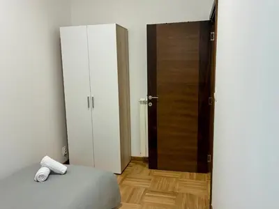 a bedroom with a bed and an open door at VHome in Belgrade