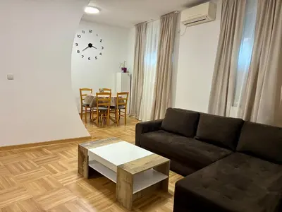 a living room with a couch and a table at VHome in Belgrade