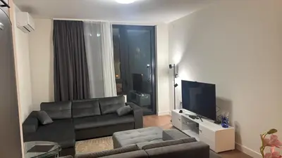 a living room with a couch and a flat screen tv at BW Premium Apartment Wolf-free parking in Belgrade