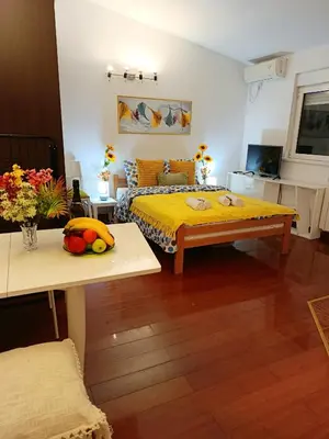 a bedroom with a bed with a yellow bedspread at Urban Garden Apartments - Sunflower 2 in Belgrade