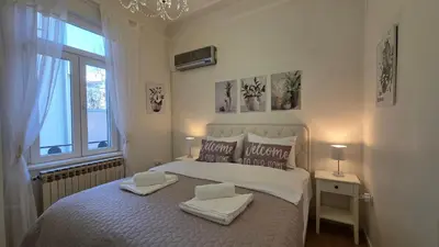 a bedroom with a large bed with two towels on it at Vracar Luxury Apartment in Belgrade