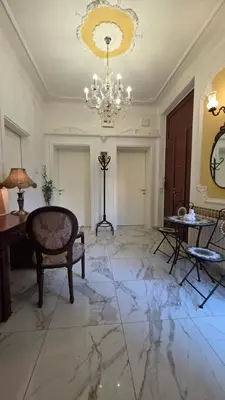 a large living room with a chandelier and marble floor at Vracar Luxury Apartment in Belgrade