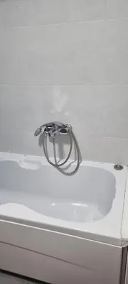 a bath tub with a faucet on top of it at Vena in Belgrade