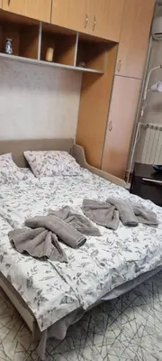 an unmade bed with clothes on it in a room at Vena in Belgrade