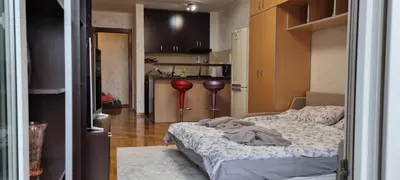 a small room with a bed and a kitchen at Vena in Belgrade