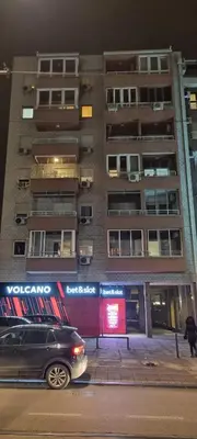 a car parked in front of a tall building at Vena in Belgrade