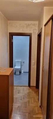 a bathroom with a toilet and a door to a room at Vena in Belgrade