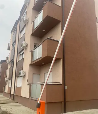 a pole leaning against the side of a building at Teja- new apartment for 4 person with free parking space in Belgrade