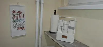 a bathroom with a shelf with toilet paper on it at Retiro Apartman in Belgrade