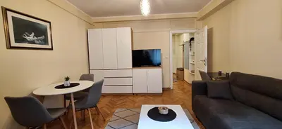 a living room with a couch and a table at Retiro Apartman in Belgrade