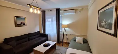 a living room with a couch and a table at Retiro Apartman in Belgrade