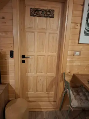 a door to a cabin with a sign on it at Kuće za odmor Banstolija - Fruška Gora in Čortanovci