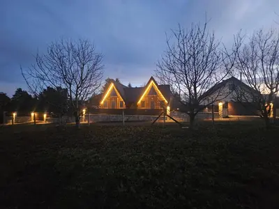a house lit up at night with lights at Kuće za odmor Banstolija - Fruška Gora in Čortanovci