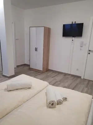a white room with two towels on a bed at Beosan in Belgrade