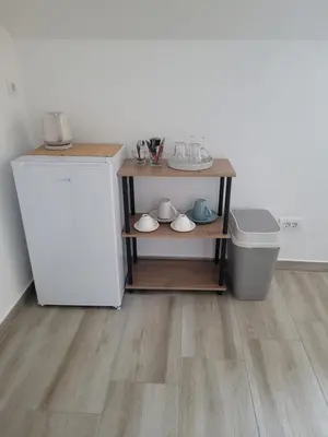 a kitchen with a white refrigerator and a trash can at Beosan in Belgrade
