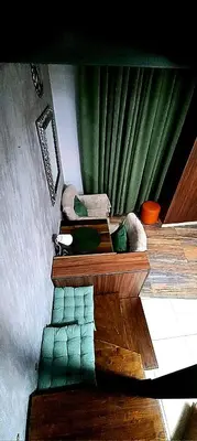 a living room with green curtains and a couch at Apartment Cabin-Style in Belgrade