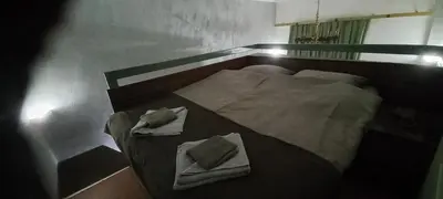 a small bed with two towels on top of it at Apartment Cabin-Style in Belgrade