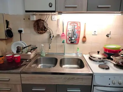 a kitchen counter with a sink and a stove at Moulin ROSE in Belgrade