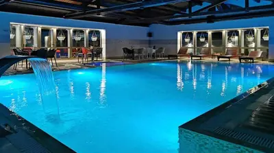 a large swimming pool with blue water at Moulin ROSE in Belgrade